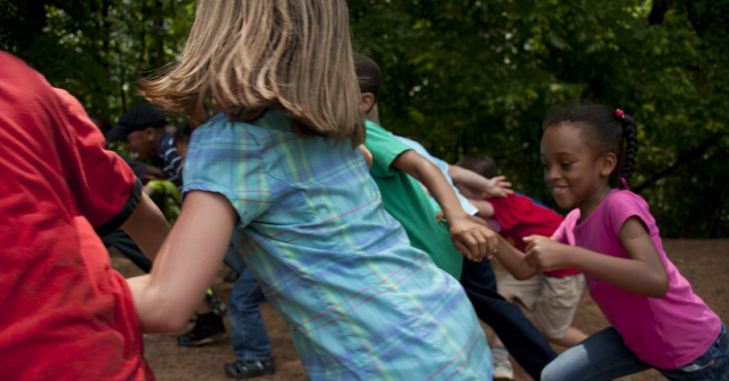 children racing outside a school.