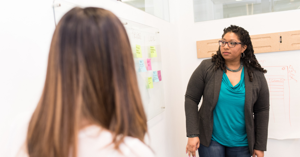 A Black and white teacher in a discussion.  Photo by Christina @ wocintechchat.com on Unsplash