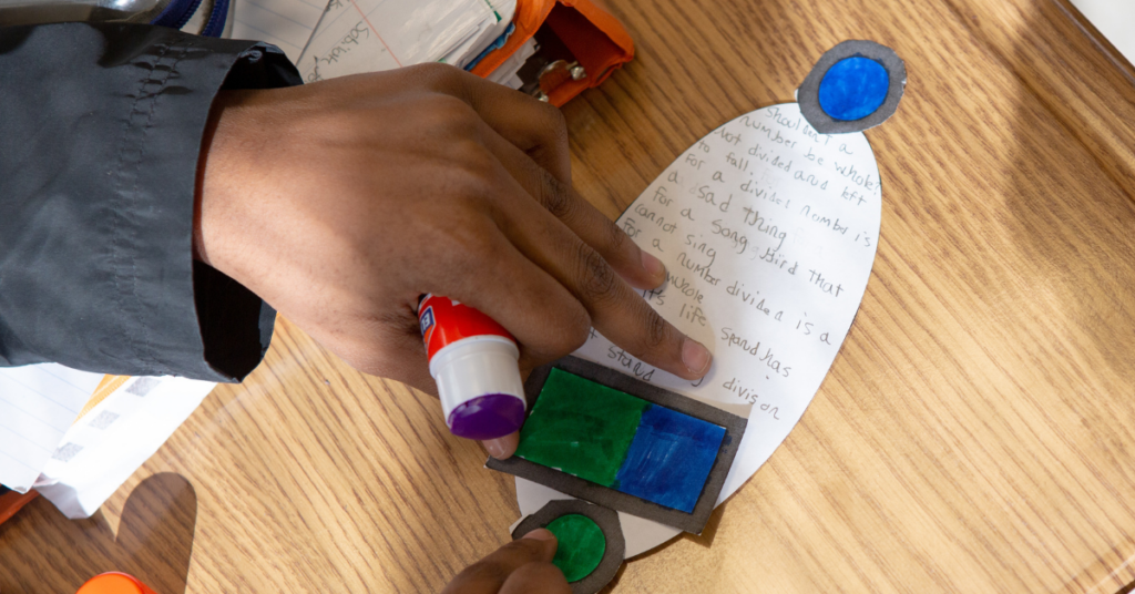 Student working with markers at school.