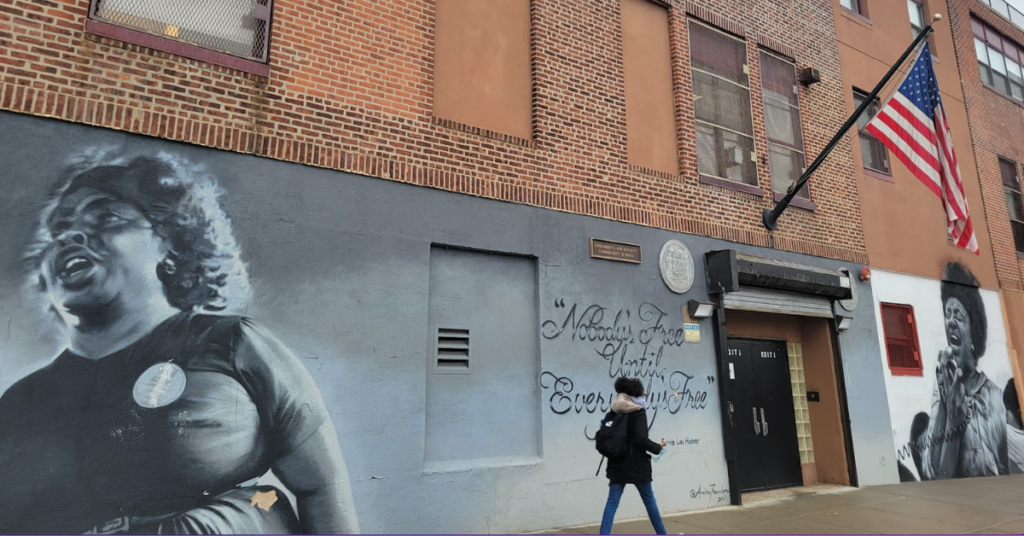 Student walking outside Fannie Lou Hamer Freedom HS in the Bronx.