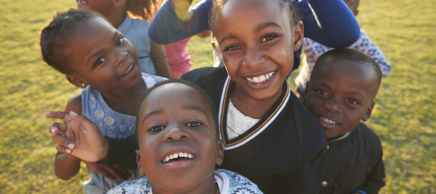 A group of Black children smiling at camera