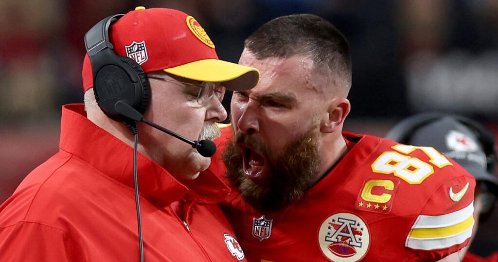 NFL football player Travis Kelse screaming in his coach Andy Reid's face during Super Bowl LVII on the football field