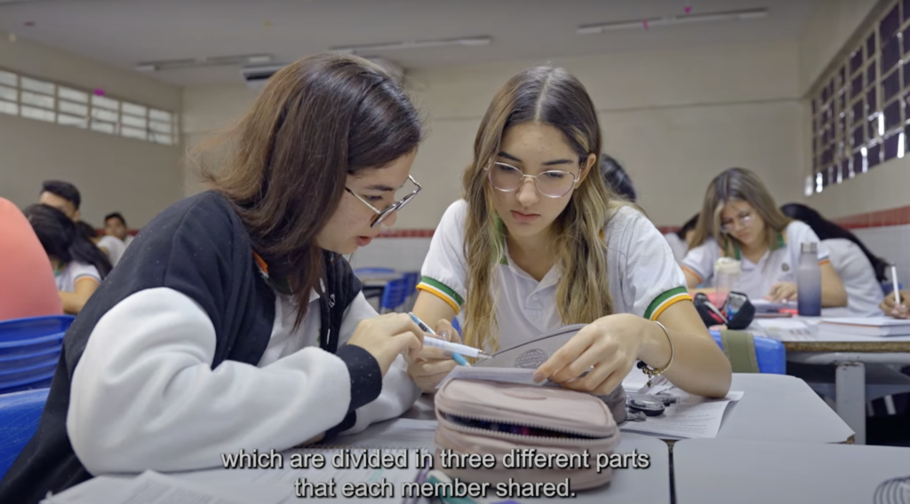 Two female students in Cipo, Brazil, engaging in peer to peer learning.