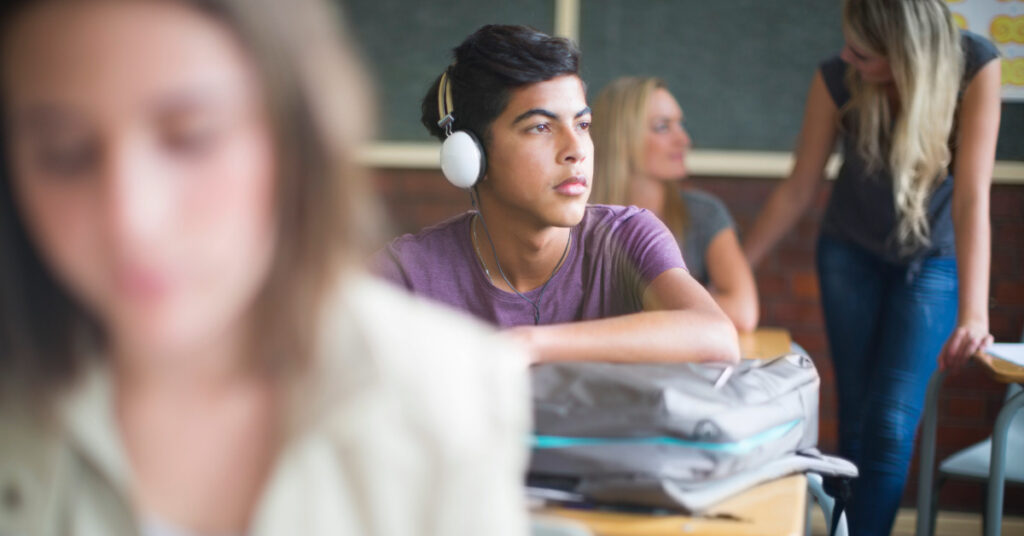 Student wearing headphones in classroom