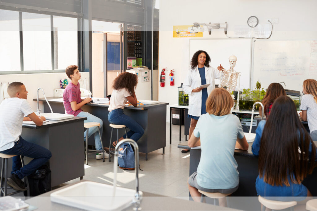 Teacher addressing pupils in a high school science lesson