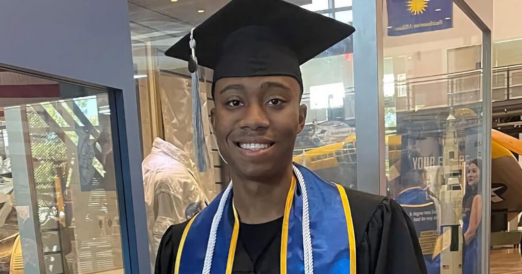 Kegan Martindale-Hernandez dressed in regalia at his graduate school graduation ceremony.