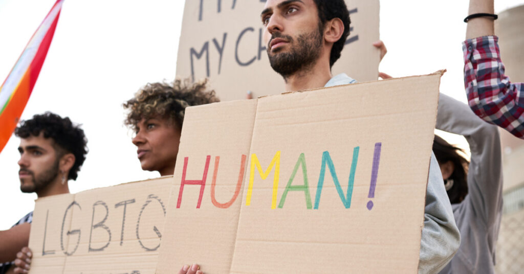 Activists protesting discrimination holding banners, LGBT community. Human rights.