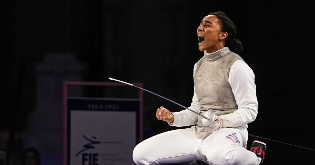 Lauren Scruggs on her knees celebrating her history-making Olympic fencing win in 2024