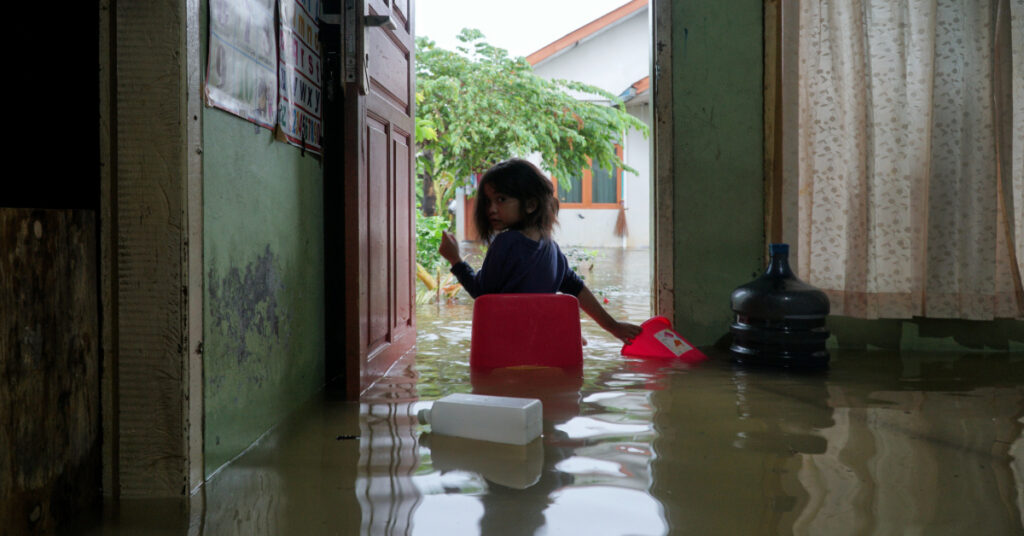 A little girl sat at the door of the house when it was hit by a flood