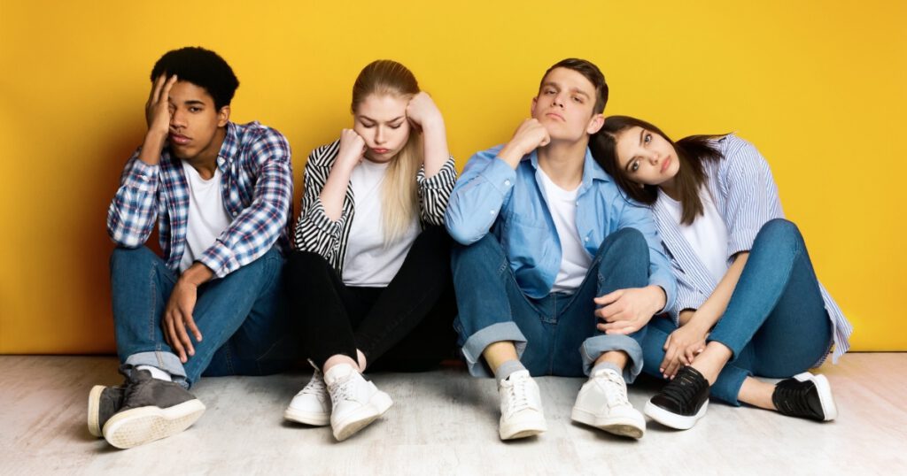 Young Diverse Friends Sitting Together Looking Tired and Bored