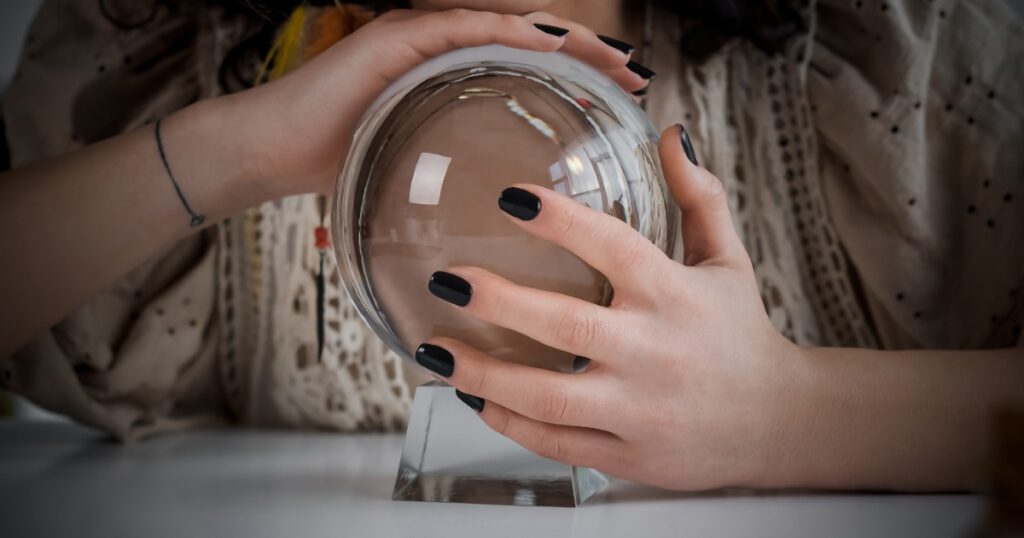 Cropped view of medium holding magic orb at home, banner