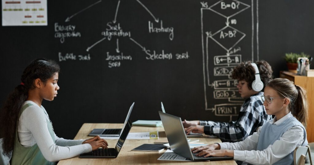 Children learning to work with computer program