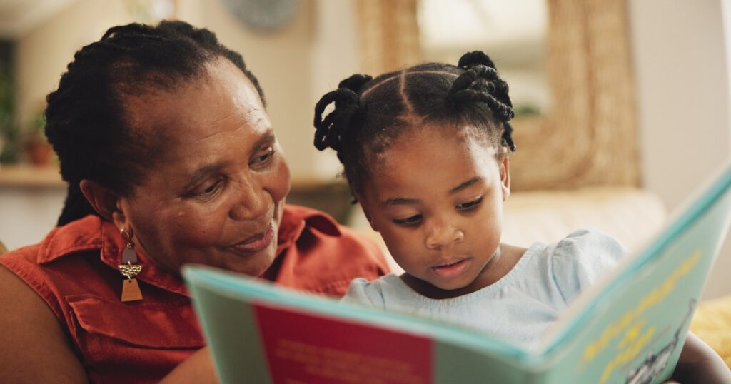 Happy, grandmother and child with book for education, learning literature and fantasy storytelling
