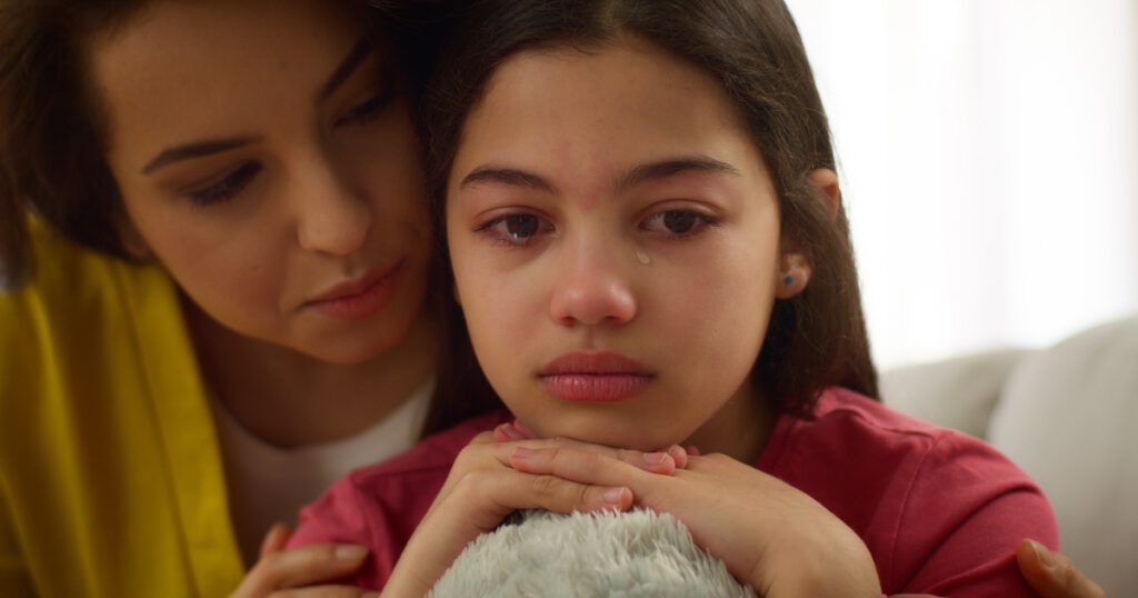 Close up Latina girl crying sad anxious depressed little girl child kid daughter cry upset by school