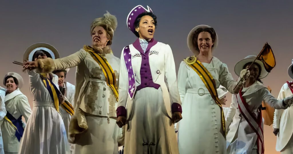 Cast of the musical Suffs with Ida B. Wells at the center.