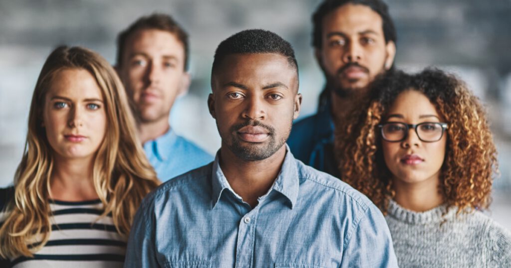 Diverse group of teachers with serious expressions, looking at the camera