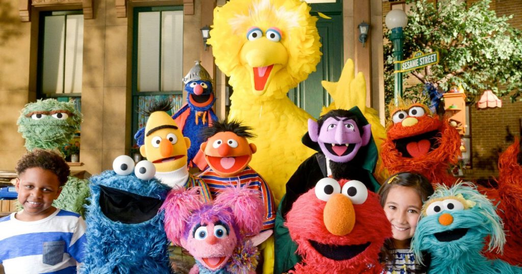 Sesame Street Muppets with two children